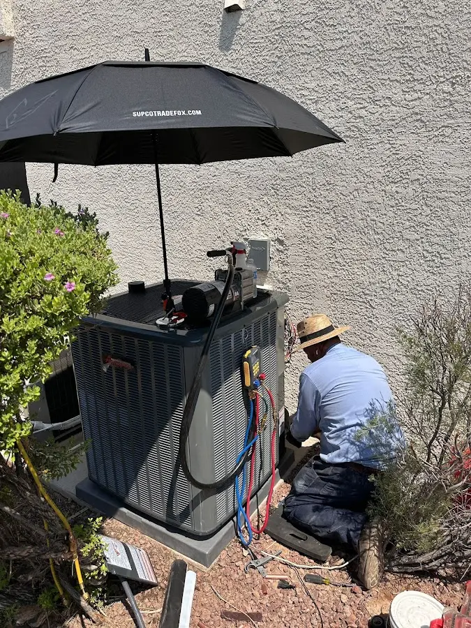 HVAC technician performing outdoor AC maintenance in Noblesville