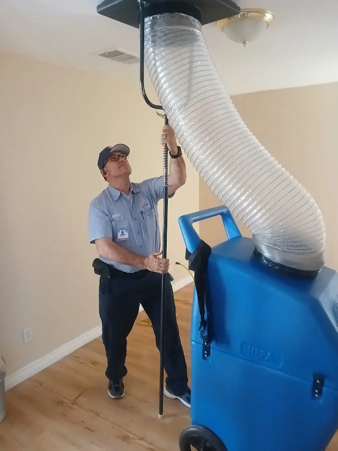 Furnace Tune-Up technician using HEPA equipment in Noblesville