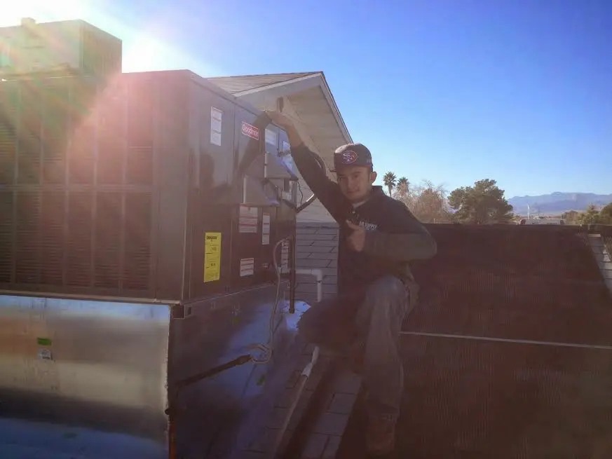 HVAC technician performing Air Duct Cleaning on a rooftop unit in Noblesville